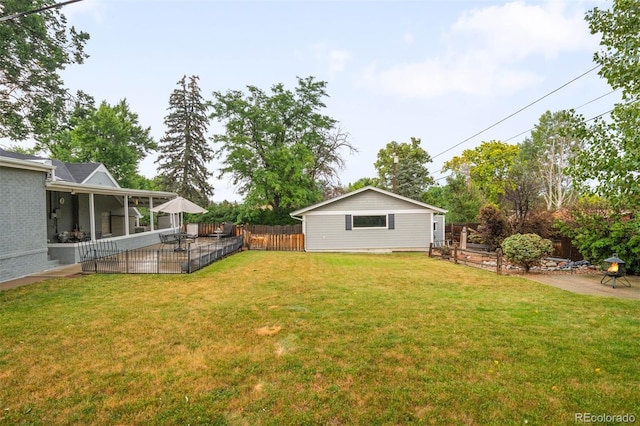 3888 Estes St, Wheat Ridge, CO 80033 - fenced backyard featuring a sunroom and a patio