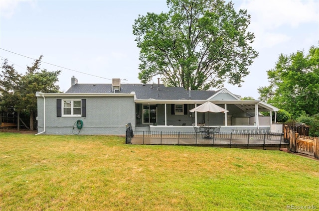 3888 Estes St, Wheat Ridge, CO 80033 - back of property with a sunroom, a patio area, and a chimney