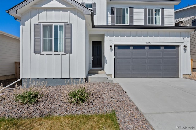 view of front facade featuring board and batten siding, an attached garage, and concrete driveway