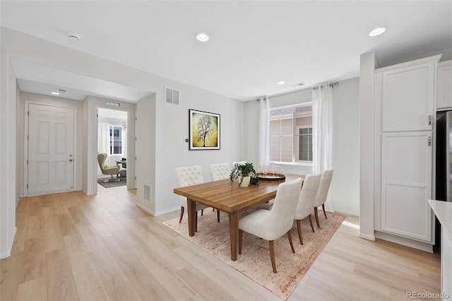 dining room with light wood finished floors, recessed lighting, and baseboards