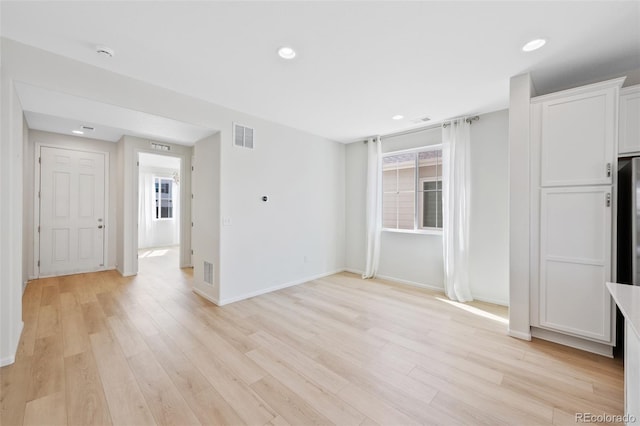 unfurnished living room with light wood-style floors, recessed lighting, and baseboards