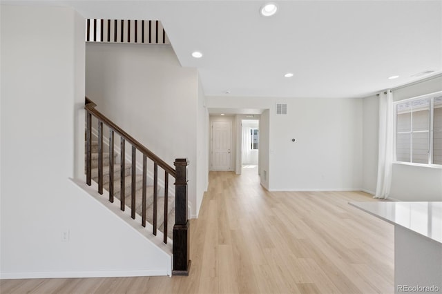 entrance foyer with light wood finished floors, recessed lighting, stairs, and baseboards