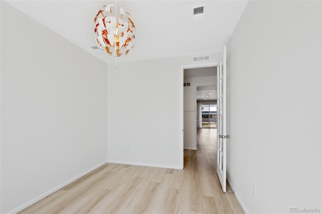 spare room with light wood-style floors and baseboards