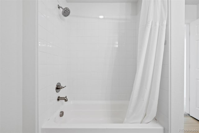 bathroom with shower / bath combination with curtain