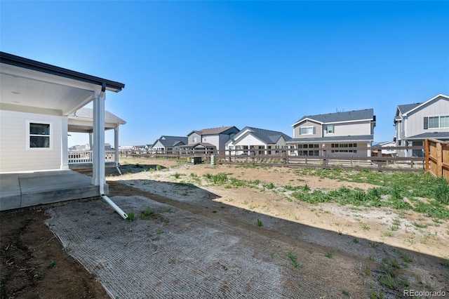 view of yard featuring fence and a residential view