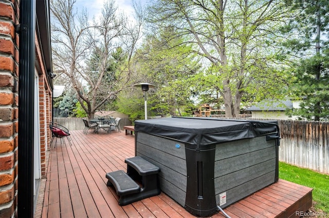 4011 S Ivy Ln, Cherry Hills Village, CO 80111 - wooden deck featuring a hot tub, outdoor dining space, and a fenced backyard