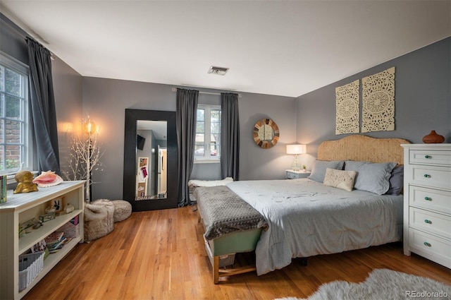 4011 S Ivy Ln, Cherry Hills Village, CO 80111 - bedroom with multiple windows and light wood-style flooring