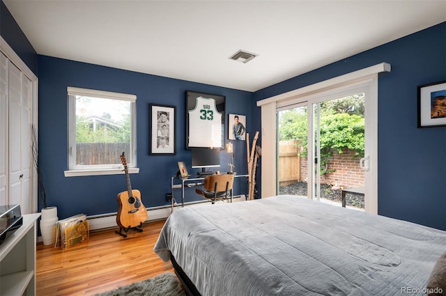 4011 S Ivy Ln, Cherry Hills Village, CO 80111 - bedroom with multiple windows, wood finished floors, access to outside, and a closet