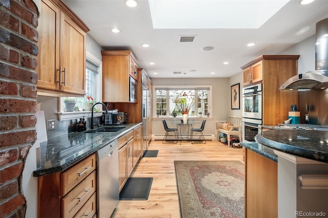 4011 S Ivy Ln, Cherry Hills Village, CO 80111 - kitchen featuring stainless steel appliances, wall chimney exhaust hood, light wood-style flooring, a baseboard heating unit, and recessed lighting