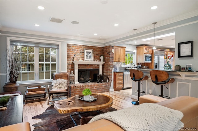 4011 S Ivy Ln, Cherry Hills Village, CO 80111 - living room with light wood finished floors, crown molding, recessed lighting, and a fireplace