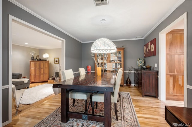 4011 S Ivy Ln, Cherry Hills Village, CO 80111 - dining space with light wood-style floors, ornamental molding, and a chandelier
