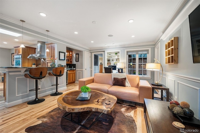 4011 S Ivy Ln, Cherry Hills Village, CO 80111 - living area with light wood-style flooring, crown molding, built in features, recessed lighting, and a decorative wall