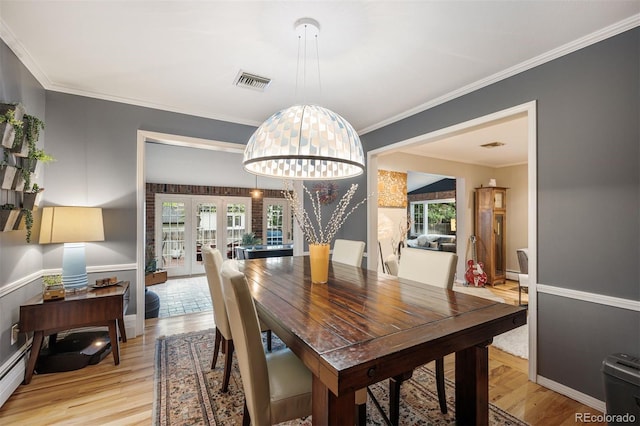 4011 S Ivy Ln, Cherry Hills Village, CO 80111 - dining room featuring light wood-type flooring, healthy amount of natural light, ornamental molding, and a chandelier