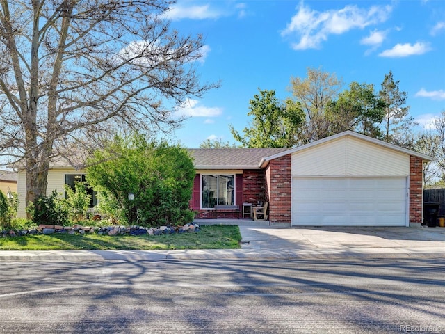ranch-style home with concrete driveway, brick siding, and a garage