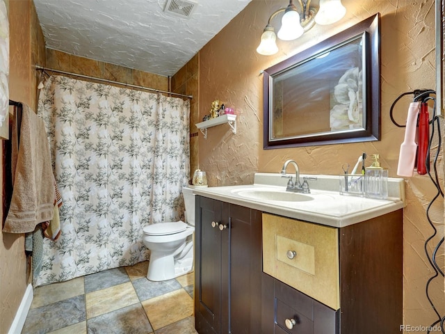 bathroom with a shower with curtain, visible vents, vanity, toilet, and a textured wall