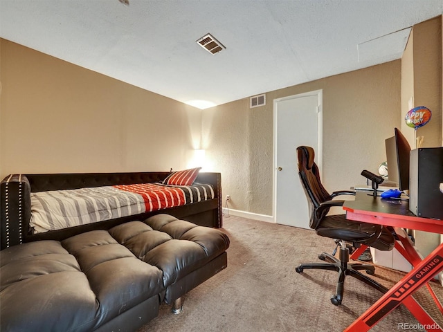bedroom featuring carpet flooring, a textured wall, visible vents, and baseboards
