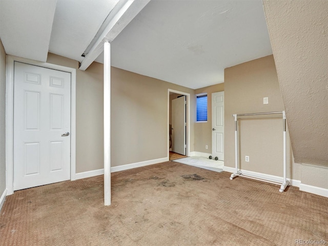 unfurnished living room with baseboards and carpet