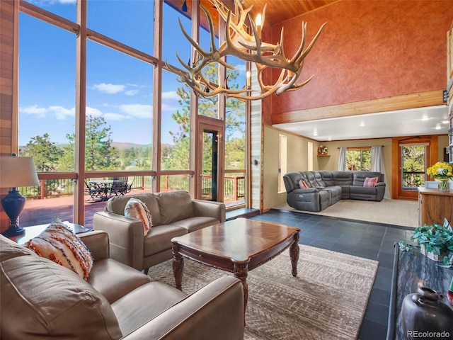 8791 Grizzly Way, Evergreen, CO 80439 - living area featuring a towering ceiling, tile patterned flooring, and wood ceiling