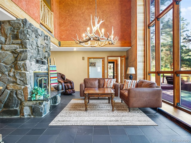 8791 Grizzly Way, Evergreen, CO 80439 - living area with a towering ceiling, a chandelier, a fireplace, and dark tile patterned flooring