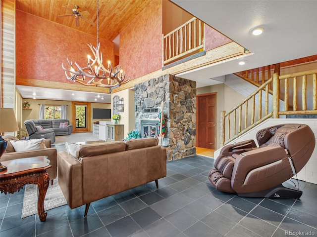 8791 Grizzly Way, Evergreen, CO 80439 - living area featuring a towering ceiling, a chandelier, dark tile patterned flooring, stairway, and wood ceiling