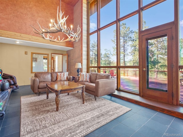 8791 Grizzly Way, Evergreen, CO 80439 - tiled living room with a towering ceiling and a chandelier