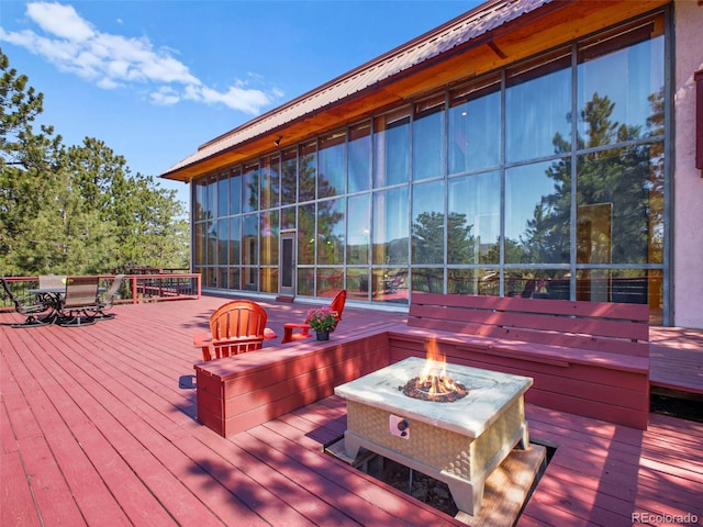 8791 Grizzly Way, Evergreen, CO 80439 - wooden deck featuring a fire pit and outdoor dining space