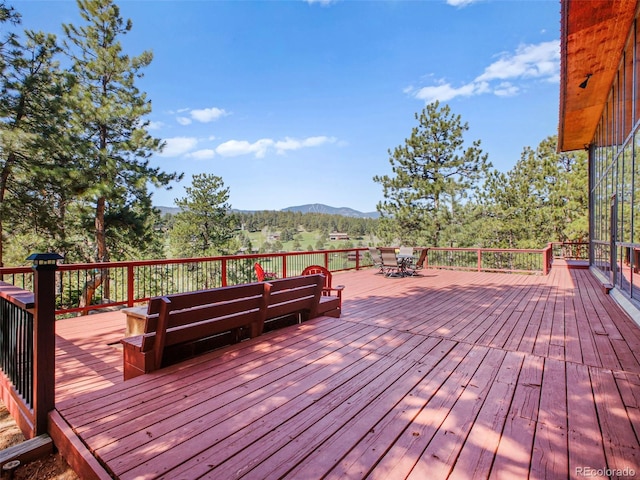 8791 Grizzly Way, Evergreen, CO 80439 - wooden terrace featuring a mountain view, outdoor dining area, and an outdoor hangout area
