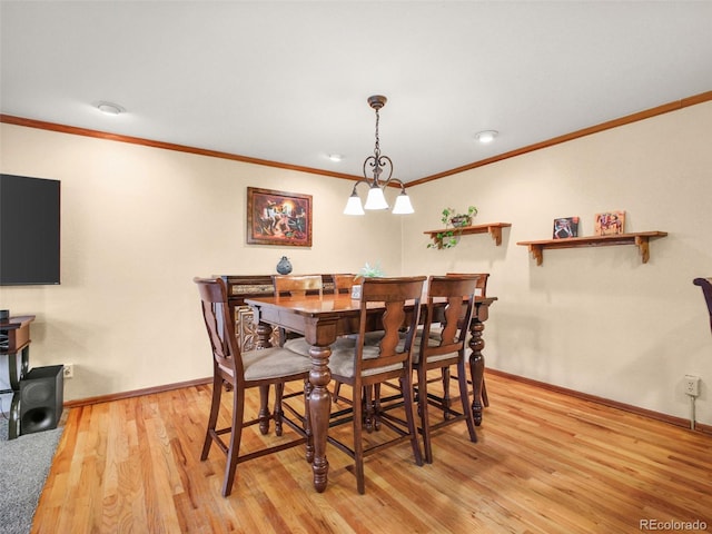 8791 Grizzly Way, Evergreen, CO 80439 - dining room with crown molding, light wood-style flooring, and baseboards
