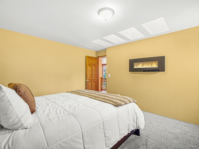 8791 Grizzly Way, Evergreen, CO 80439 - bedroom with a skylight and carpet flooring