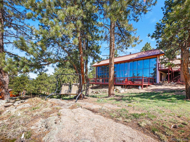 8791 Grizzly Way, Evergreen, CO 80439 - view of yard featuring a wooden deck and a sunroom