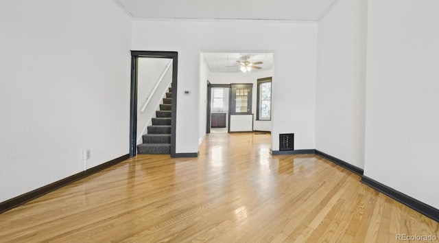 553 N Logan St, Denver, CO 80203 - spare room with light wood finished floors, stairway, baseboards, and visible vents