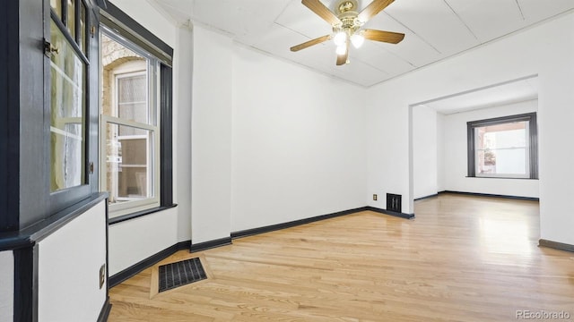 553 N Logan St, Denver, CO 80203 - unfurnished room with light wood-type flooring, visible vents, baseboards, and a ceiling fan
