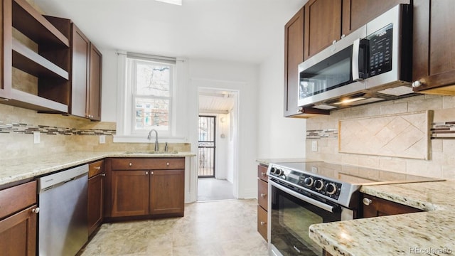 553 N Logan St, Denver, CO 80203 - kitchen with open shelves, a wealth of natural light, appliances with stainless steel finishes, and a sink