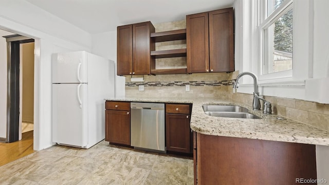 553 N Logan St, Denver, CO 80203 - kitchen with a sink, tasteful backsplash, freestanding refrigerator, open shelves, and stainless steel dishwasher