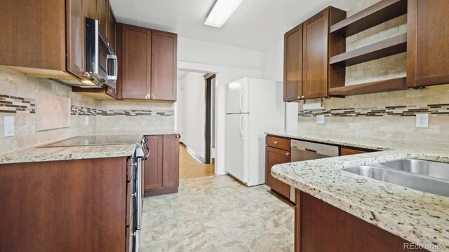 553 N Logan St, Denver, CO 80203 - kitchen featuring open shelves, appliances with stainless steel finishes, tasteful backsplash, and light stone countertops
