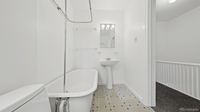 553 N Logan St, Denver, CO 80203 - full bath featuring a soaking tub, tile patterned floors, toilet, and baseboards