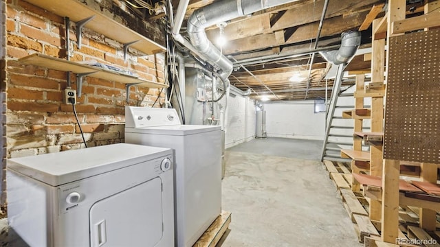 553 N Logan St, Denver, CO 80203 - unfinished below grade area featuring brick wall, gas water heater, and independent washer and dryer
