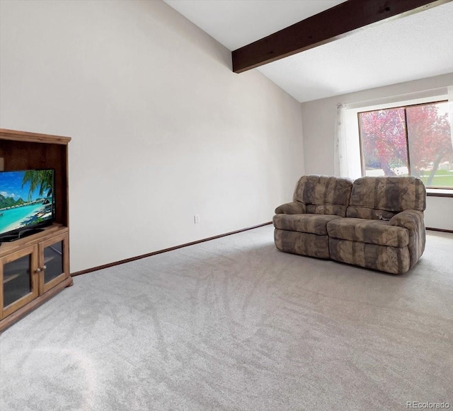 carpeted living area with baseboards and beamed ceiling