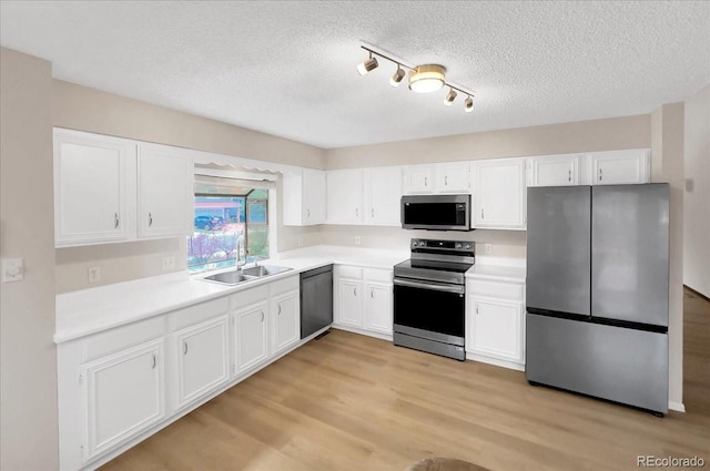 kitchen featuring a sink, white cabinetry, and appliances with stainless steel finishes