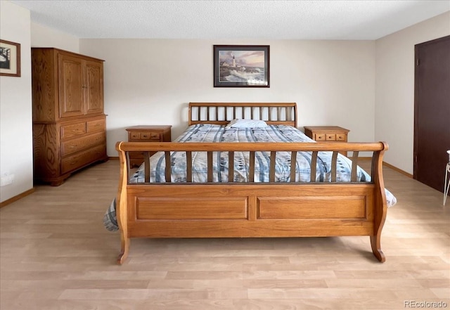 bedroom featuring baseboards and light wood-type flooring