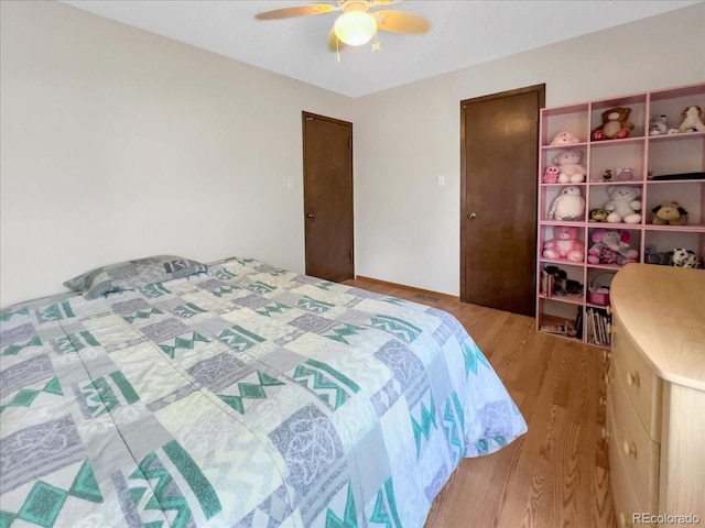 bedroom featuring a ceiling fan and wood finished floors
