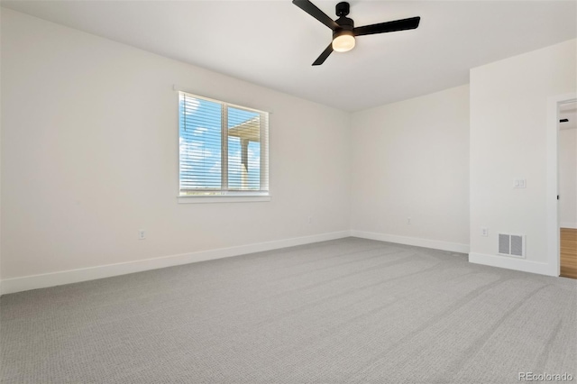 unfurnished room with ceiling fan, carpet, visible vents, and baseboards