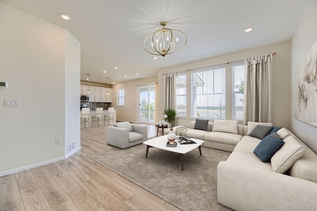 living room with recessed lighting, visible vents, light wood-style flooring, and baseboards