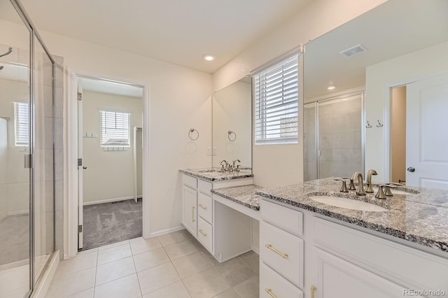 full bath with a wealth of natural light, a stall shower, and vanity