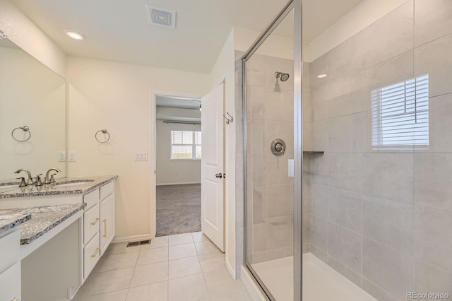 full bath with vanity, tile patterned floors, visible vents, and a stall shower