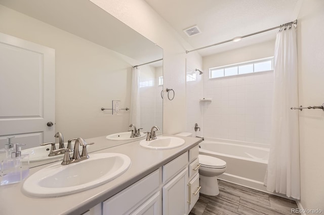 full bath featuring a sink, visible vents, and shower / bath combination with curtain