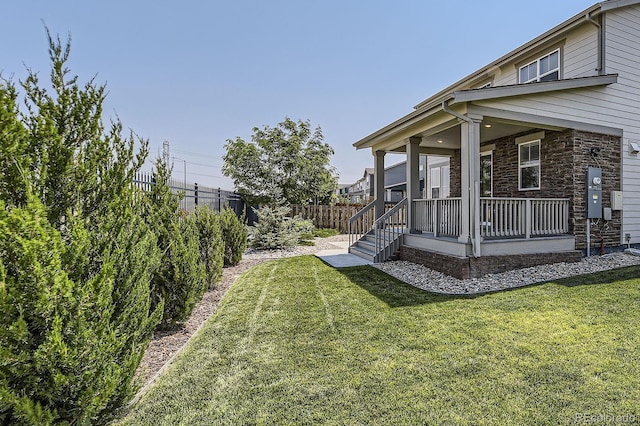 view of yard with a porch and a fenced backyard