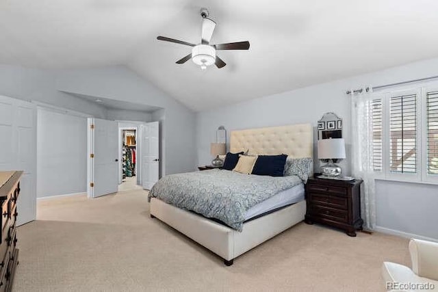 5955 Blue Sage Way, Littleton, CO 80123 - bedroom featuring light colored carpet, vaulted ceiling, and a ceiling fan