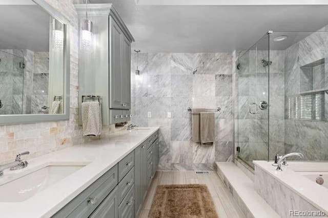 5955 Blue Sage Way, Littleton, CO 80123 - bathroom with a garden tub, a marble finish shower, and double vanity