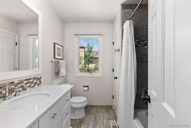 5955 Blue Sage Way, Littleton, CO 80123 - bathroom with vanity, tasteful backsplash, shower / bath combo, and wood finished floors